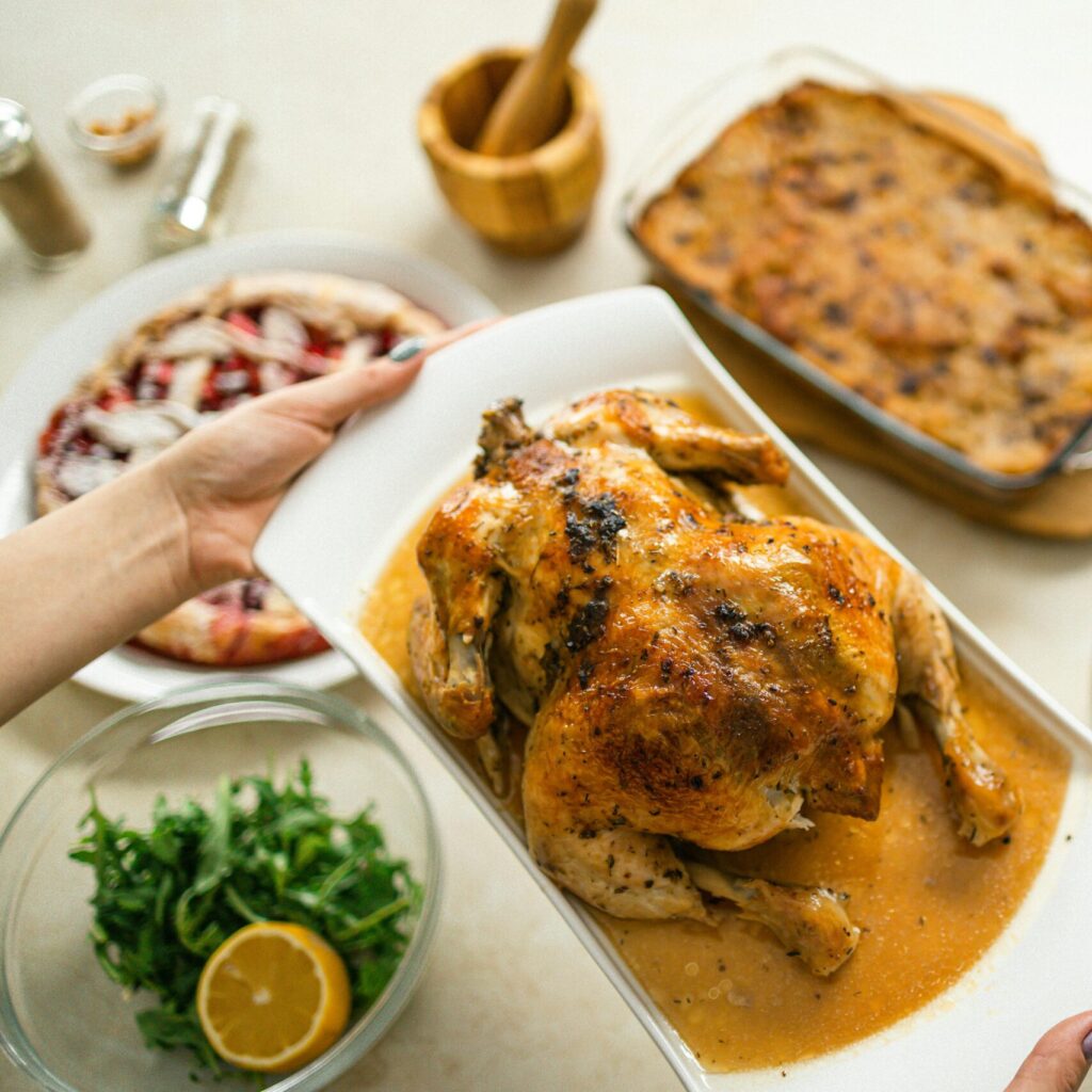 Savory roasted chicken served with fresh salad and baked side dishes.
