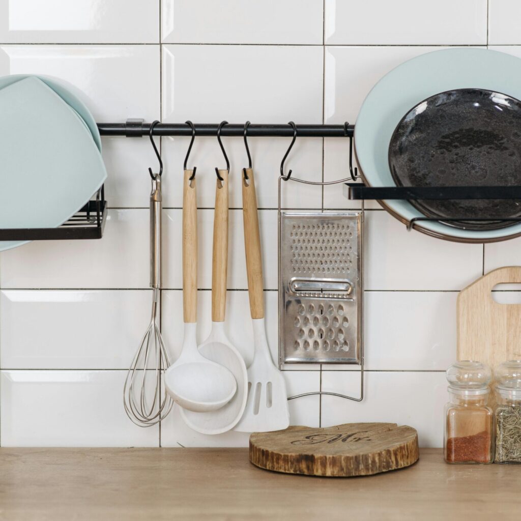 Elegant kitchen display featuring utensils, herbs, and dishware for a contemporary look.