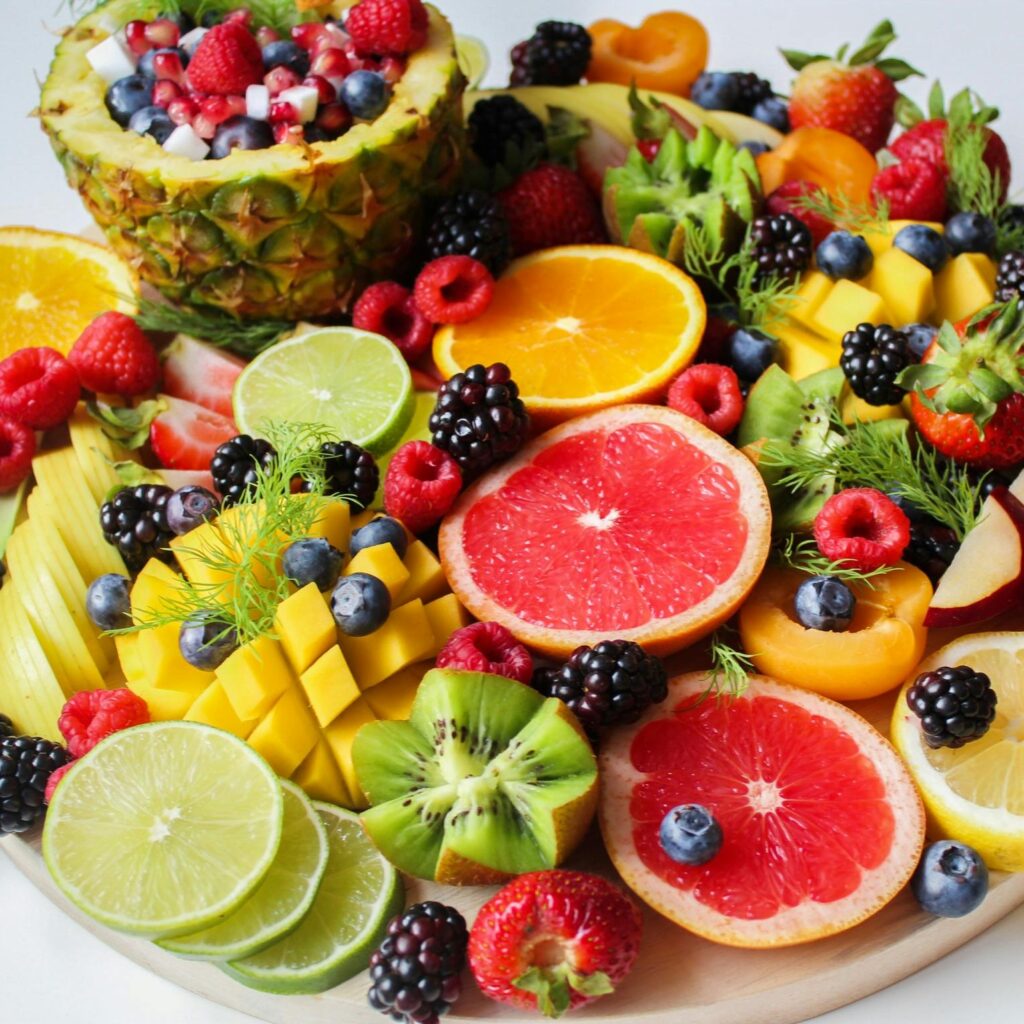 A vibrant assortment of fresh fruits beautifully arranged on a platter, perfect for a healthy and delicious snack.
